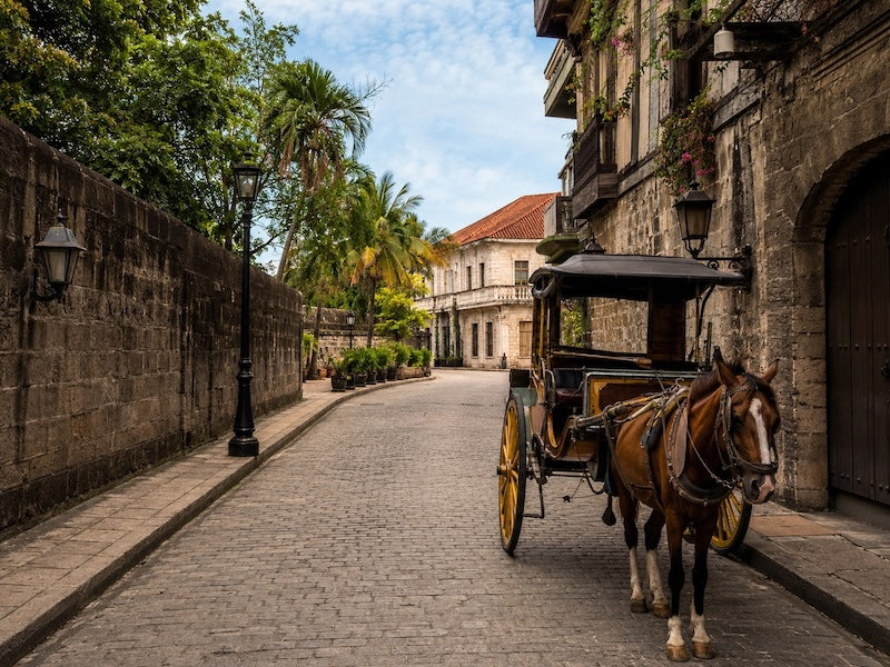 Intramuros Manila with historic stone streets and traditional horse-drawn carriage in the walled city