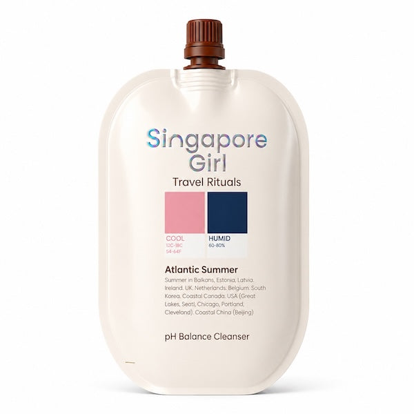 Singapore Girl Travel Rituals pH Balance Cleanser in an Atlantic Summer travel-sized squeeze pouch with a brown cap, on a white background.