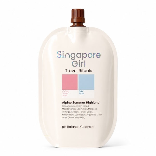 Singapore Girl Travel Rituals Alpine Summer Highland dry travel cleanser in a large cream-colored squeeze bottle with a brown cap, on a white background.