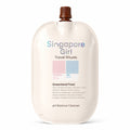 Singapore Girl Travel Rituals Greenland Frost pH Balance Cleanser travel-sized pouch in a warm off-white color, featuring a brown cap and pastel color blocks indicating freezing and dry temperatures.