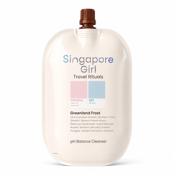 Singapore Girl Travel Rituals Greenland Frost pH Balance Cleanser travel-sized pouch in a warm off-white color, featuring a brown cap and pastel color blocks indicating freezing and dry temperatures.