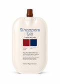 A large, rounded travel cream bottle labeled 'Singapore Girl Travel Rituals' with a brown cap, on a clean white background.