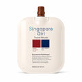 Singapore Girl Travel Rituals Equatorial Rainforest Radiance Serum travel pouch with a brown cap, on a white background.